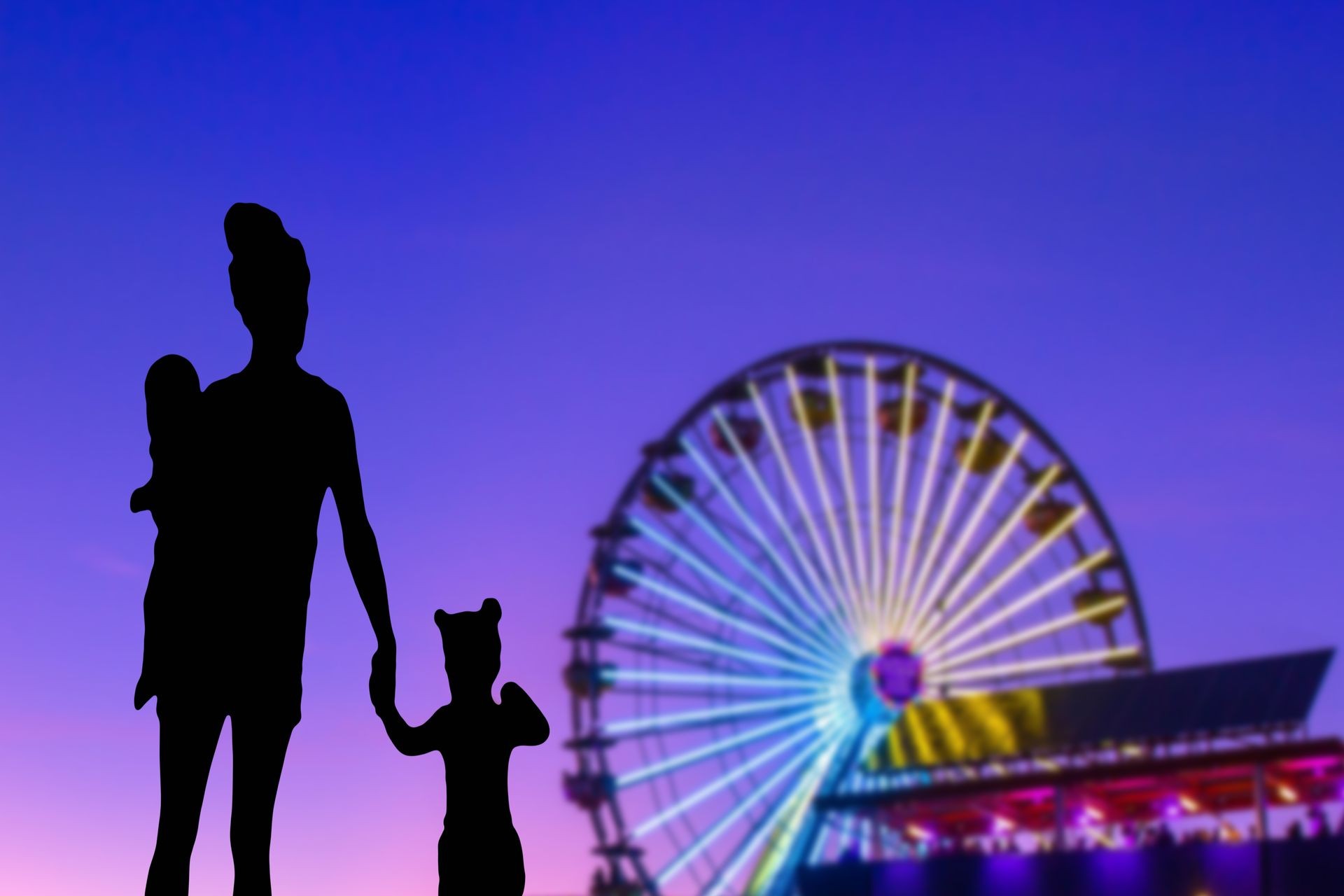 Family silhouette in a theme park looking at the ferris wheel mother with her little daughter and baby